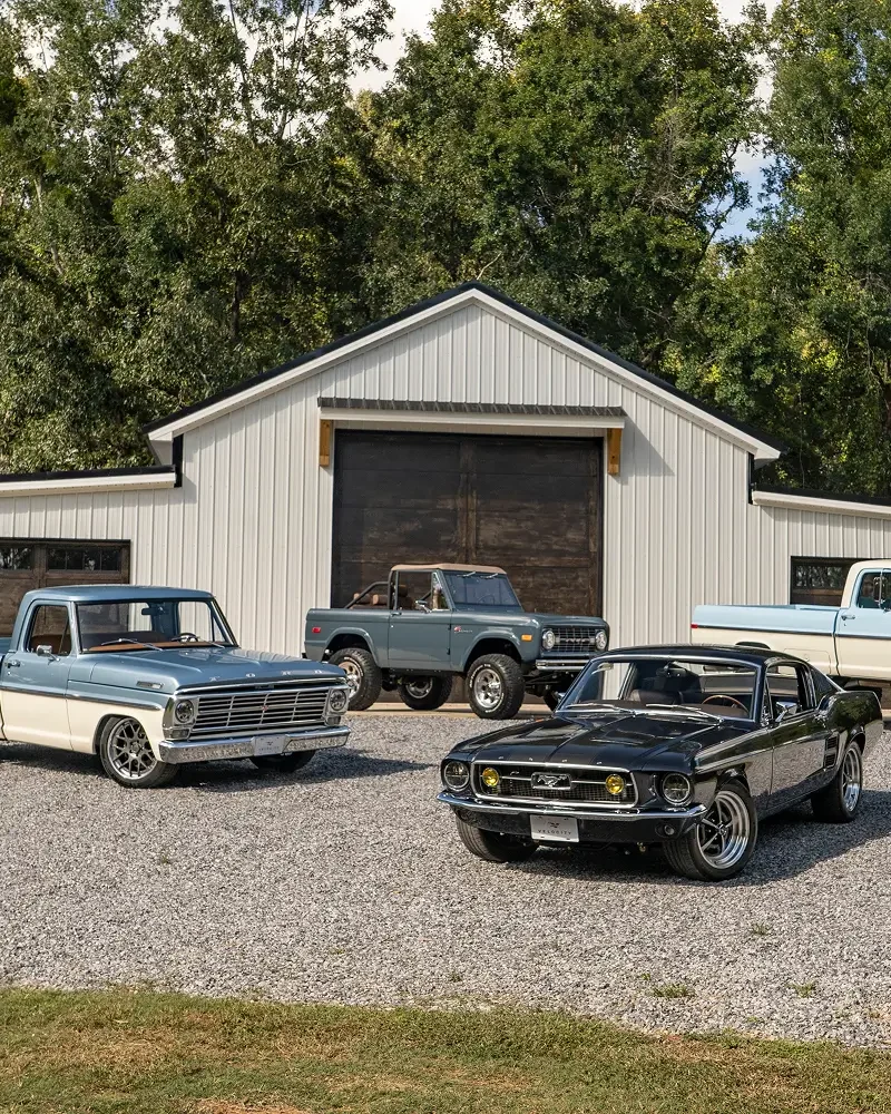 Velocity restomod classics outside a barn style garage