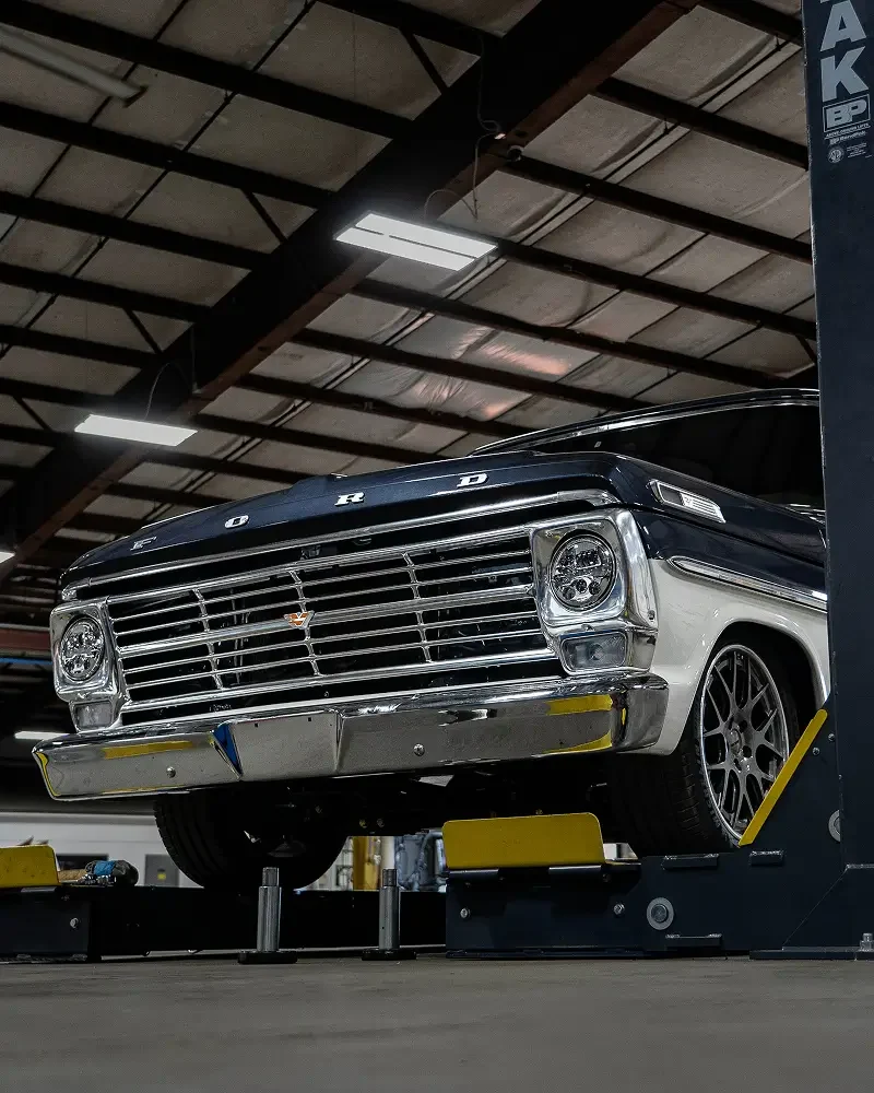 Velocity restored Ford F-100 on a ramp in the production facility