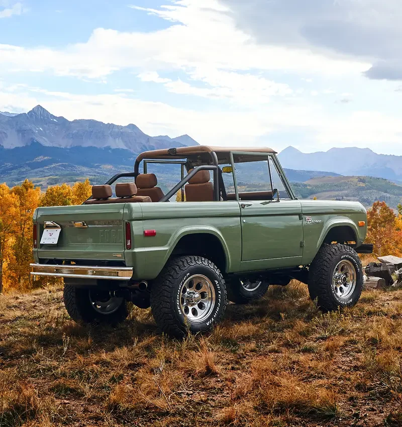 Green Velocity Ford Bronco in a mountain scene
