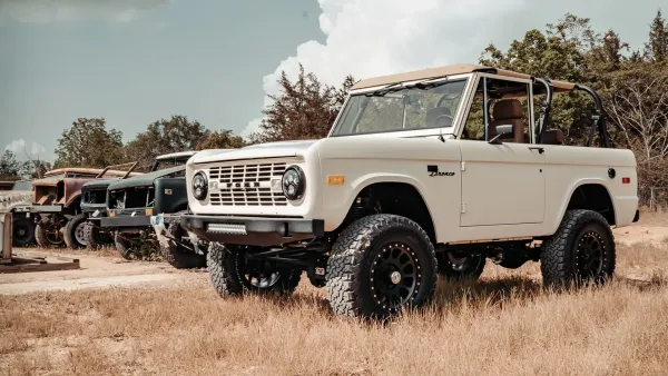 A restored Classic Bronco alongside non-restored models