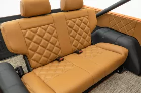 https://www.velocityrestorations.com/assets/vehicles/1506-1973pearl-orangebronco0012back-seat-sm.webp