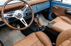 https://www.velocityrestorations.com/assets/vehicles/3469-1974-brittany-blue-bronco-14-15-driver-side-interior-sm.webp